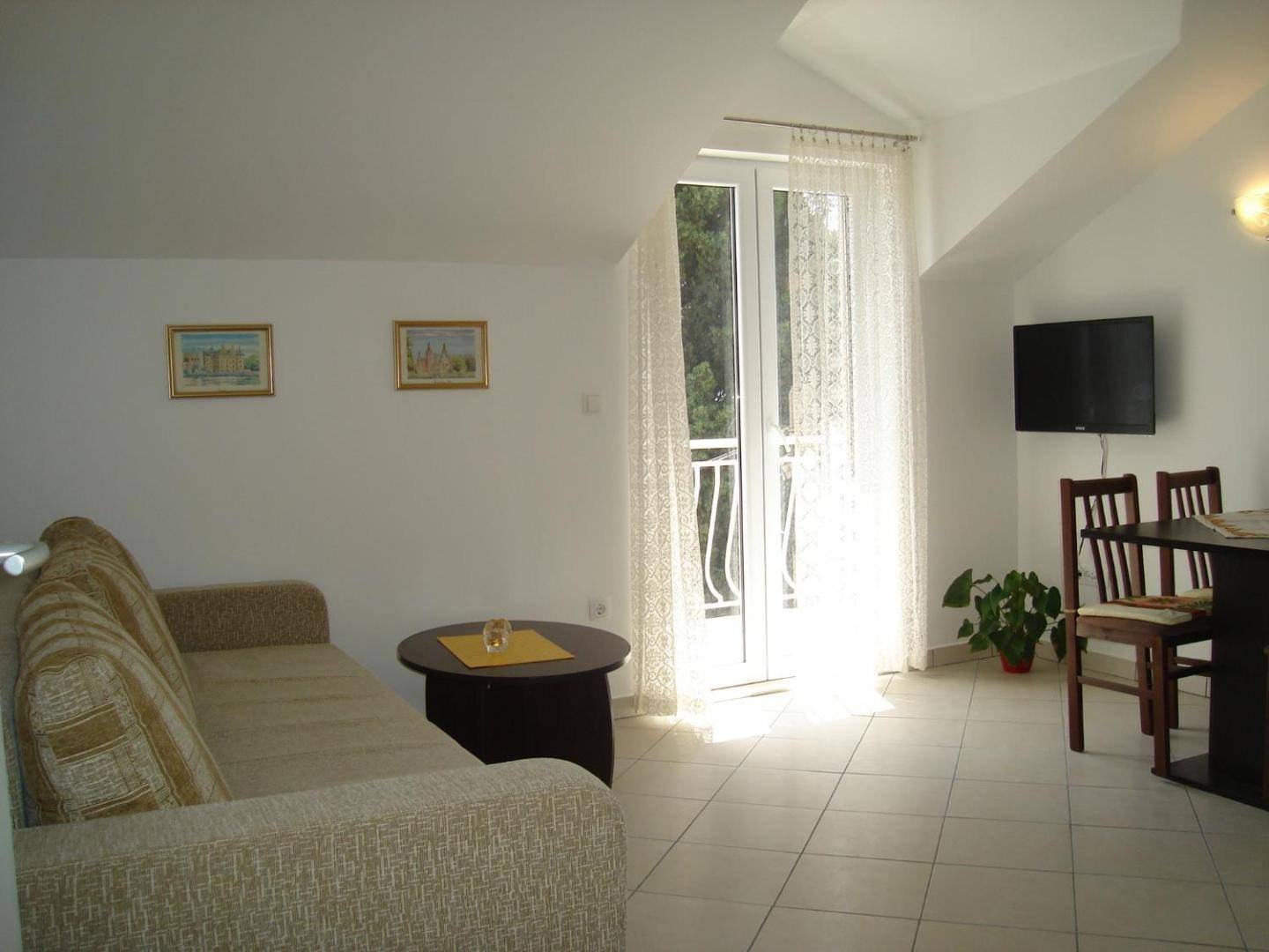 Living room with sofa bed and balcony door