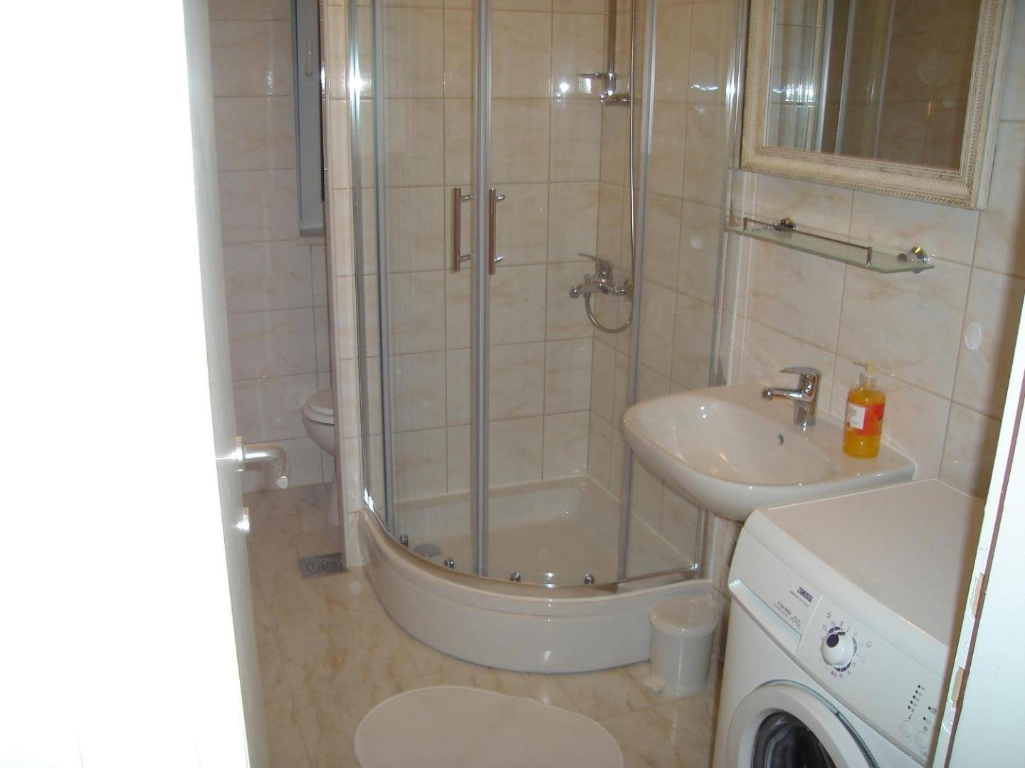 Bathroom with shower and washing machine